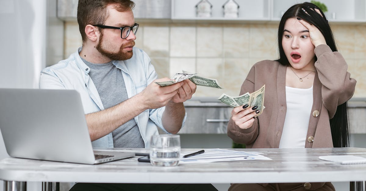 Para planująca finanse rodziny z notesami i laptopem przy stole